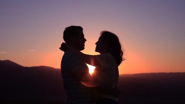 silhouette of hugging couple